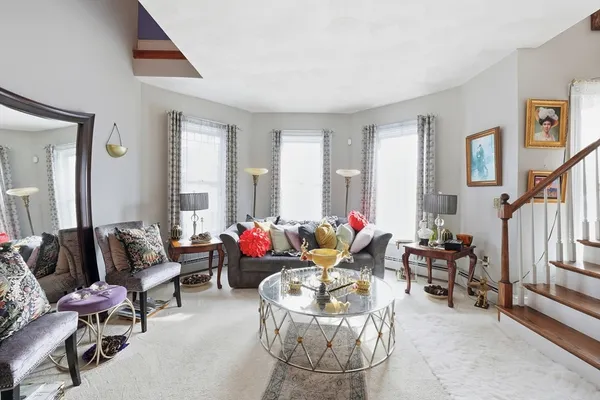 a living room with furniture and floor to ceiling windows
