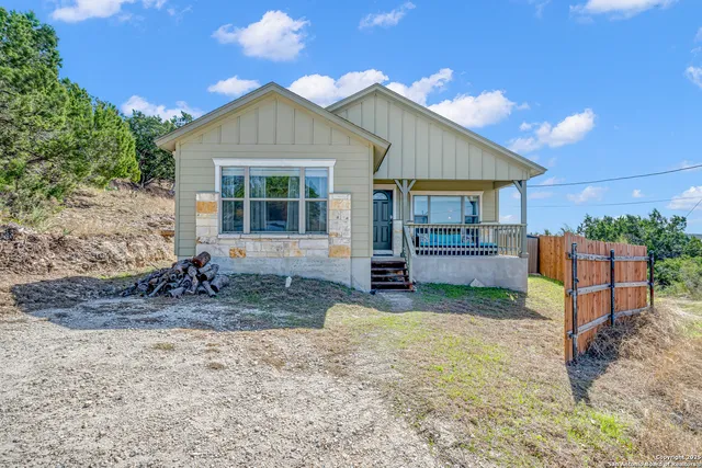 a view of a house with backyard porch and sitting area