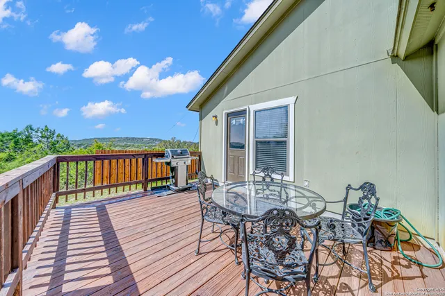 a view of a chairs and table on the deck