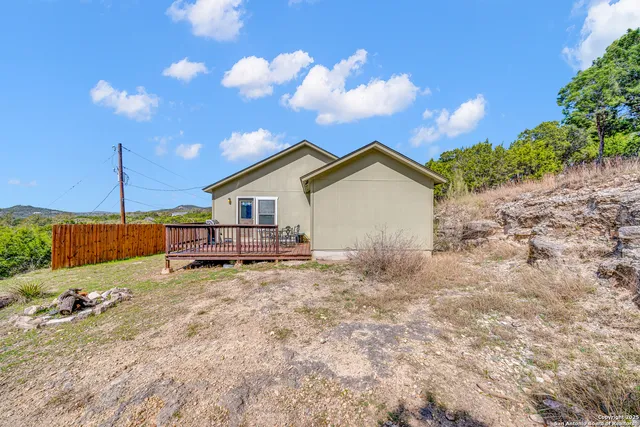 a view of a house with backyard and trees
