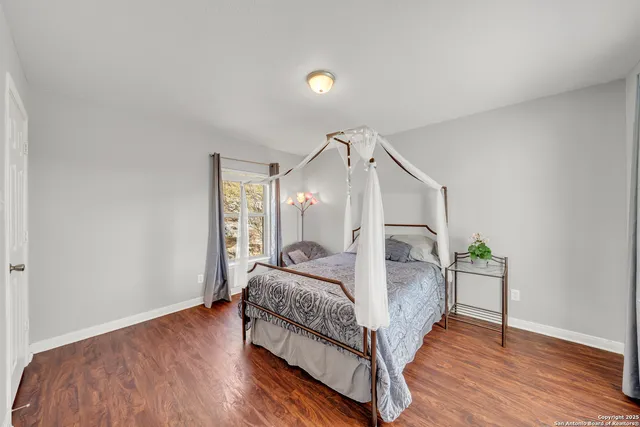 a spacious bedroom with a bed and a window