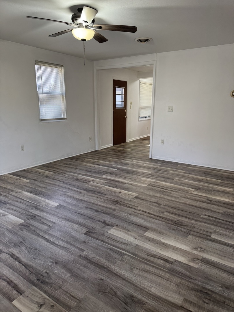 1103 37th St Court Moline, IL 61265 - Photo 5 of 13 wooden floor in an empty room with a window