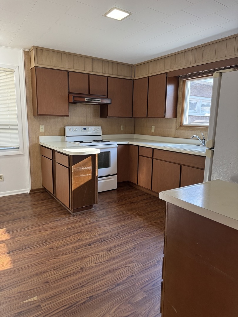 1103 37th St Court Moline, IL 61265 - Photo 8 of 13 a kitchen with stainless steel appliances granite countertop a stove a sink and a refrigerator