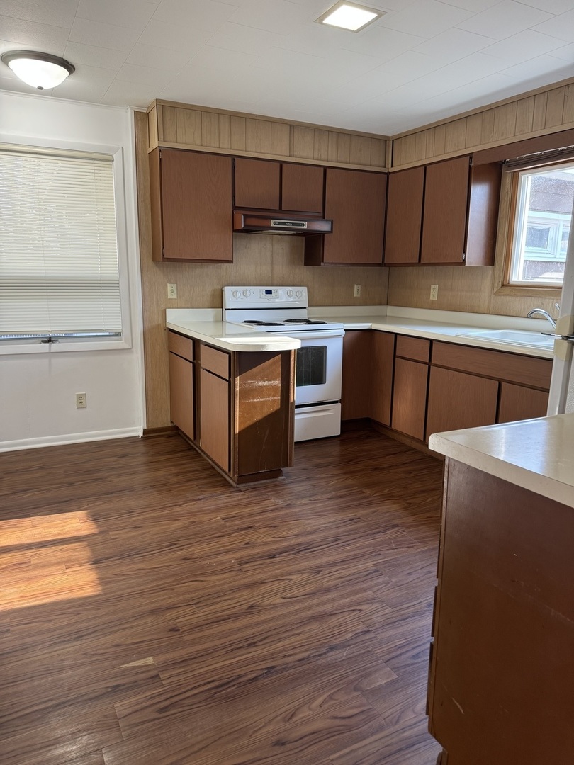 1103 37th St Court Moline, IL 61265 - Photo 9 of 13 a kitchen with stainless steel appliances kitchen island granite countertop a stove a sink and a refrigerator