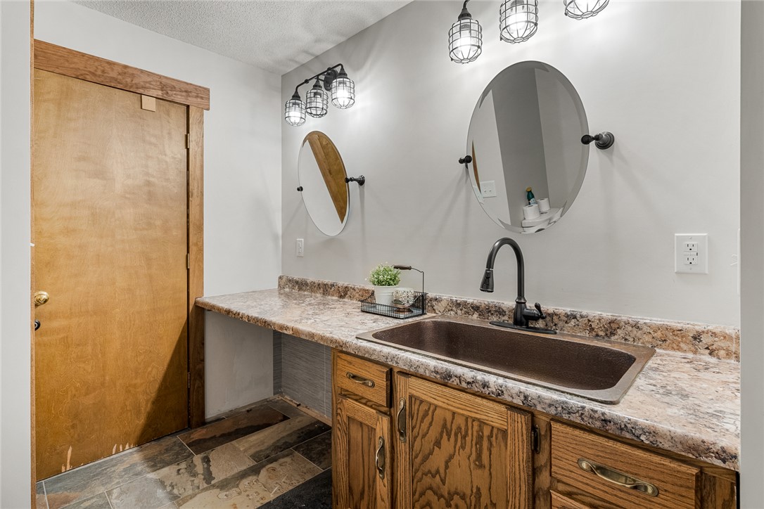2817 Providence Church Road Anderson, SC 29626 - Photo 17 of 35 A well-appointed bathroom vanity features a deep basin sink, durable countertops, and rustic wooden cabinetry.