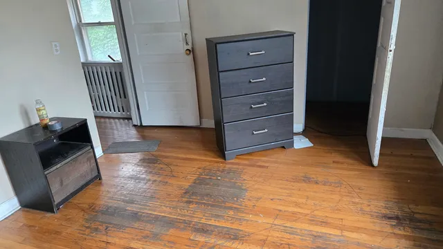 a living room with furniture and a dresser