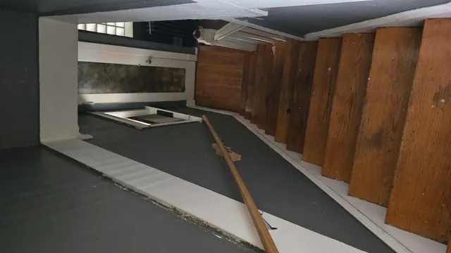 a living room with a wooden floor and a cabinet