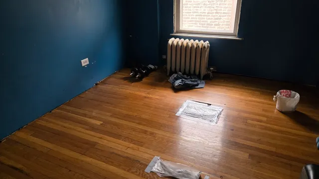 a room with hard wood floor and a window