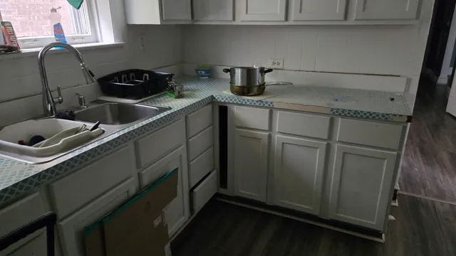 a kitchen with a sink and cabinets