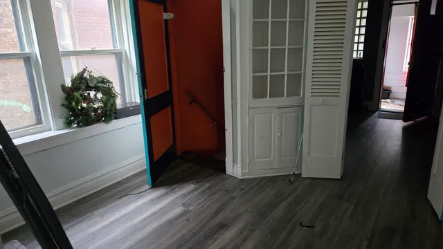 a view of front door and wooden floor