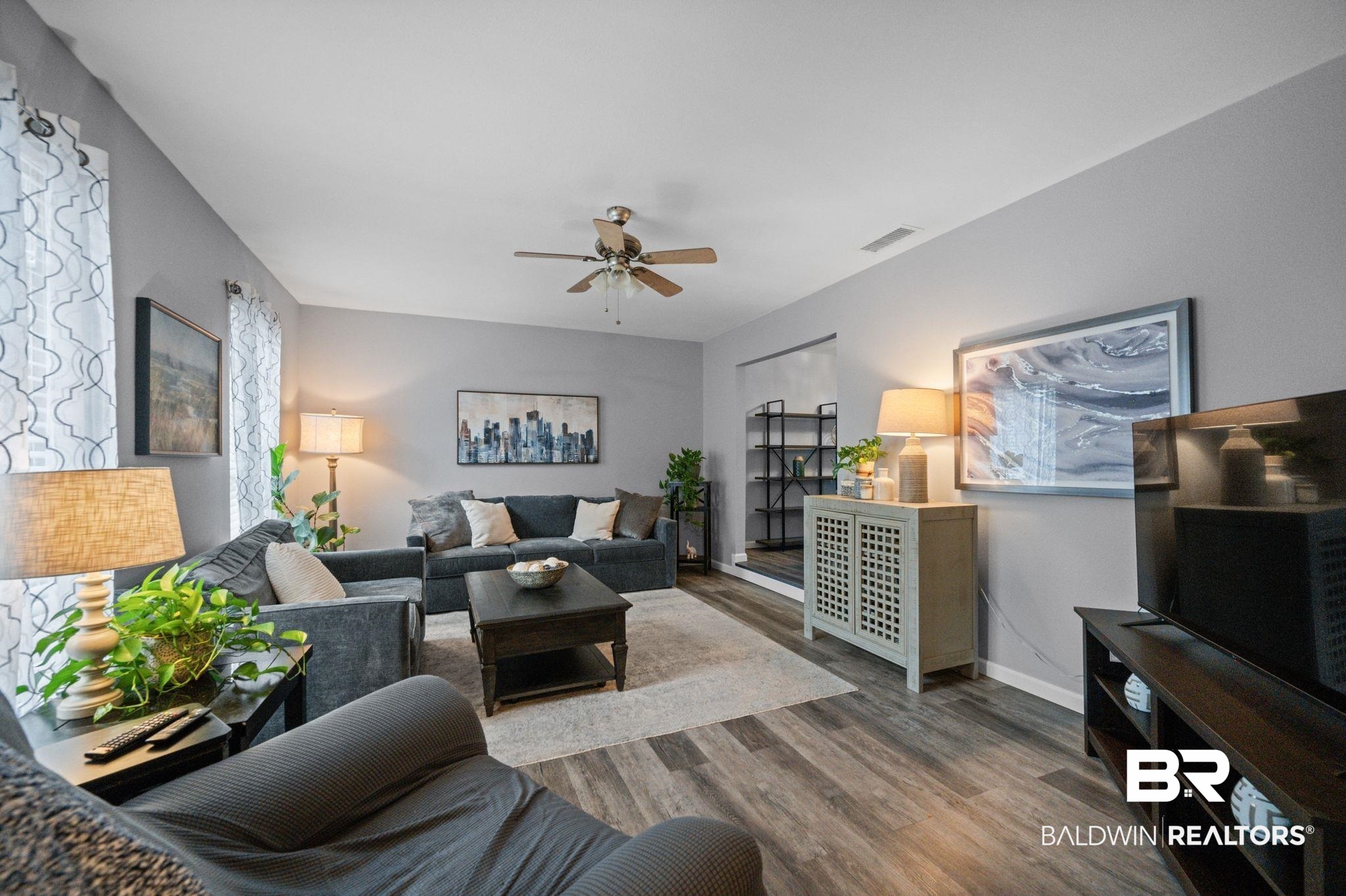 4724 Wicker Way Mobile, AL 36609 - Photo 5 of 36 Bright living room featuring light gray walls and wood-finish flooring