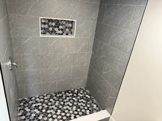 a bathroom with a shower and a sink