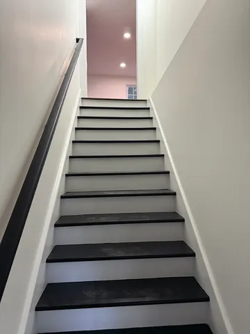 an empty room with wooden floor and a window