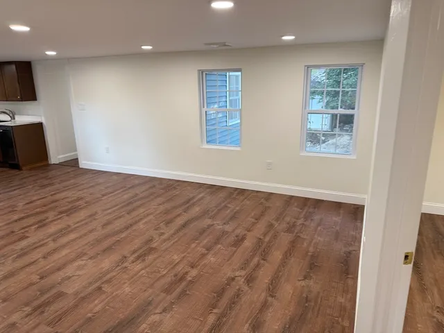 a large kitchen with stainless steel appliances granite countertop a sink and cabinets