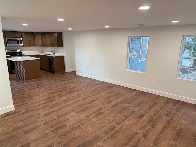 a kitchen with a stove a sink and a microwave