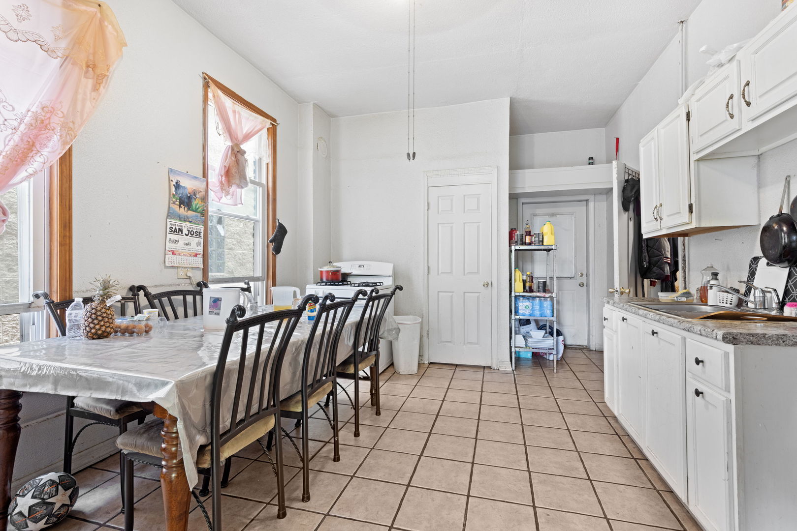 1507 West Erie Street Chicago, IL 60642 - Photo 4 of 24 a kitchen with stainless steel appliances a dining table chairs cabinets and a sink