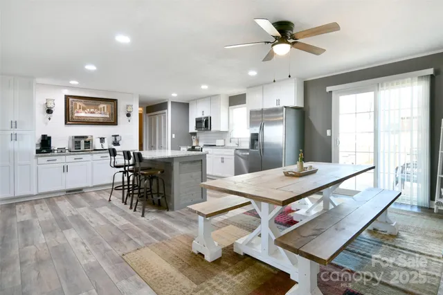 a living room with stainless steel appliances kitchen island granite countertop furniture and a kitchen view