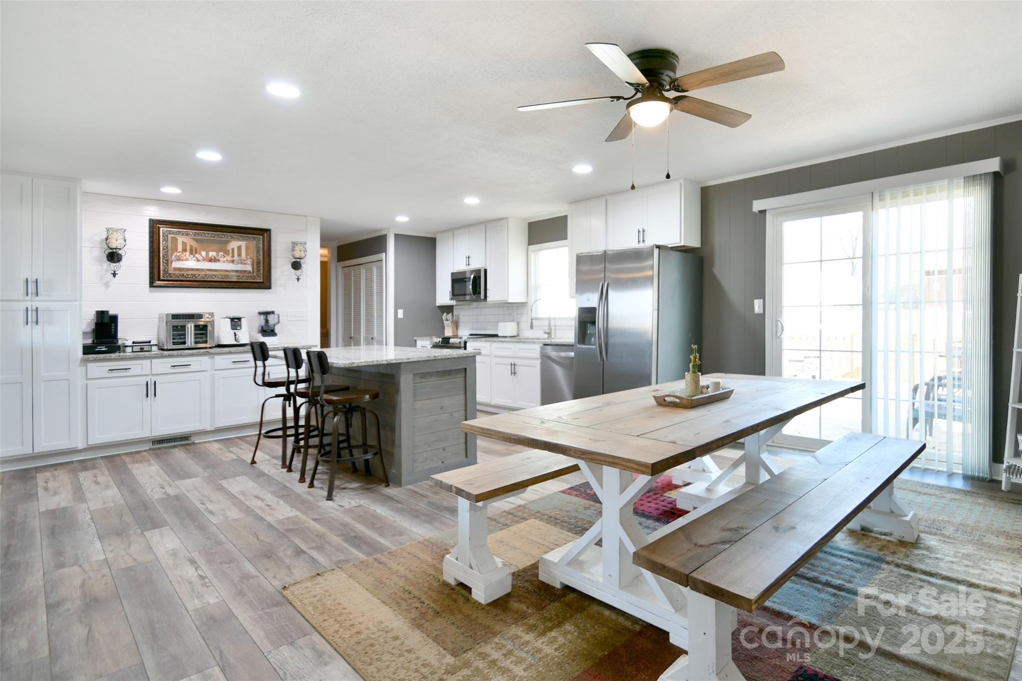 1820 Irish Potato Road Concord, NC 28025 - Photo 13 of 35 a living room with stainless steel appliances kitchen island granite countertop furniture and a kitchen view