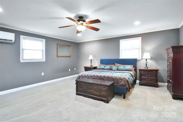 a spacious bedroom with a bed and a chandelier