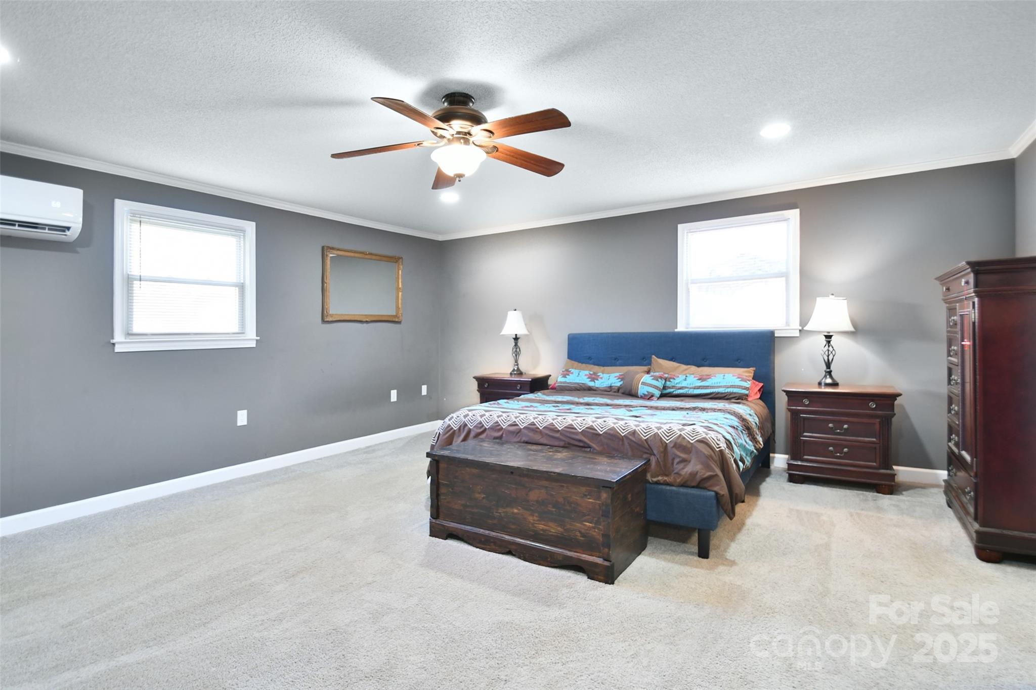 1820 Irish Potato Road Concord, NC 28025 - Photo 15 of 35 a spacious bedroom with a bed and a chandelier