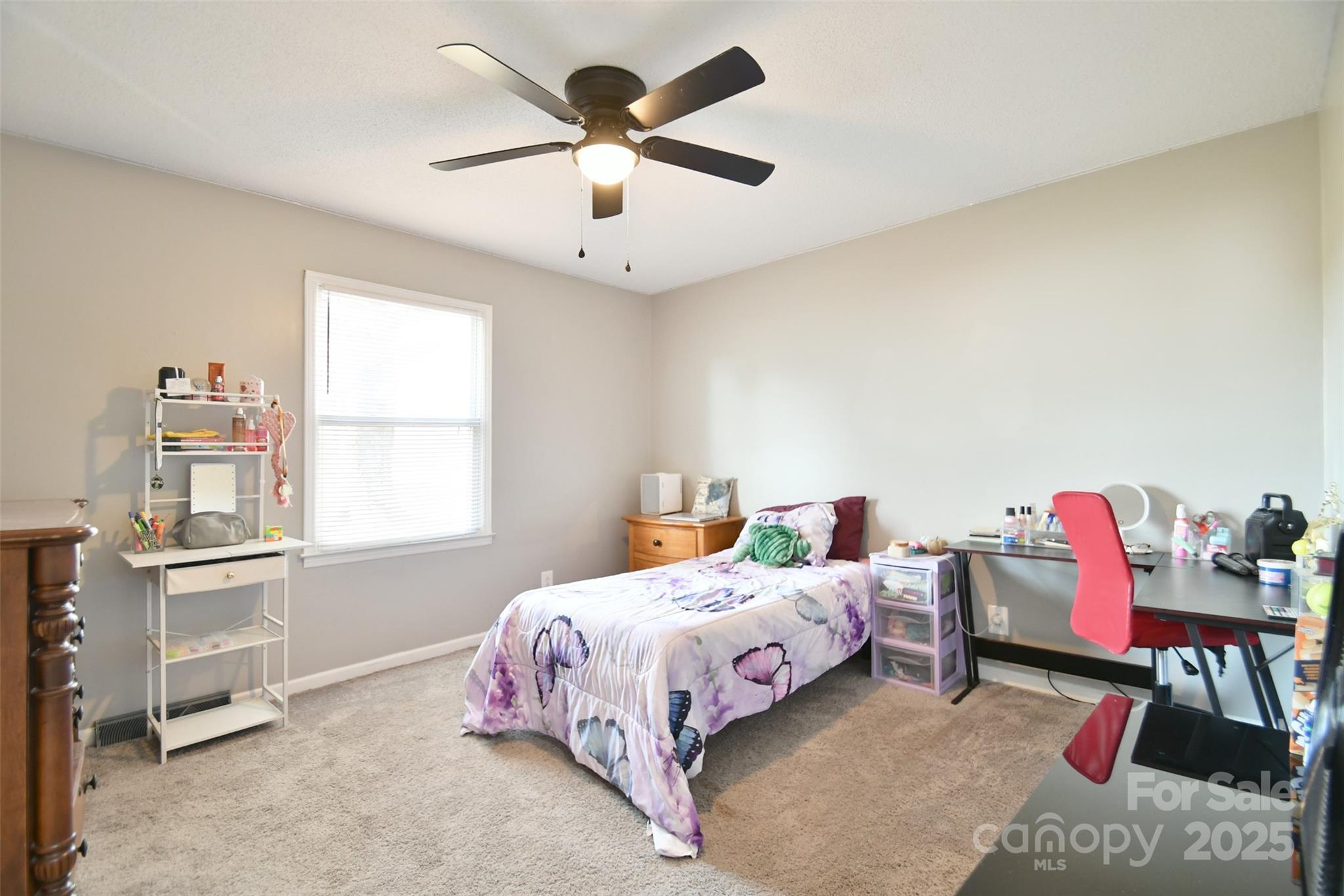 1820 Irish Potato Road Concord, NC 28025 - Photo 18 of 35 a bedroom with a bed a chandelier and a window