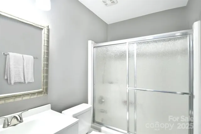 a bathroom with a shower and a sink