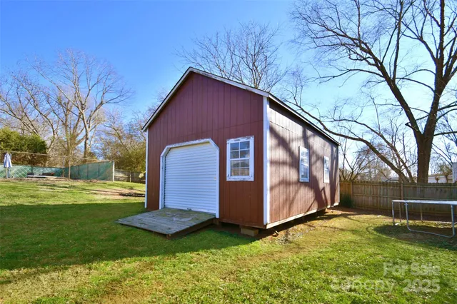 a backyard of a house with yard and trampoline