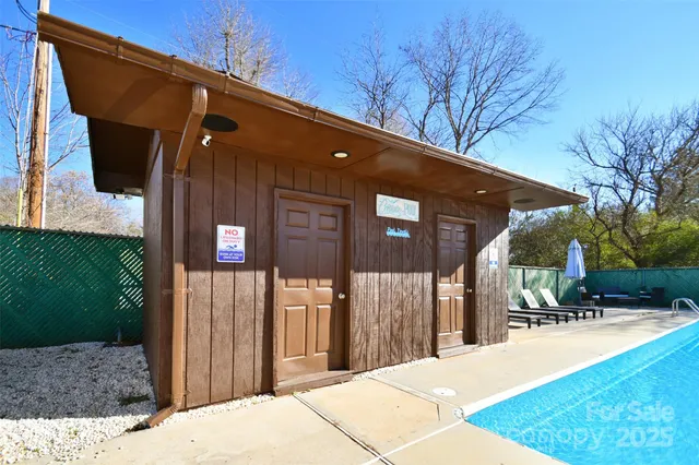 a patio with table and chairs and potted plants