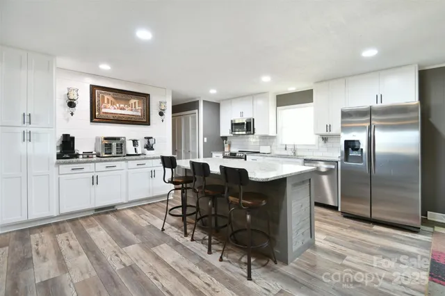 a kitchen with a sink refrigerator and cabinets