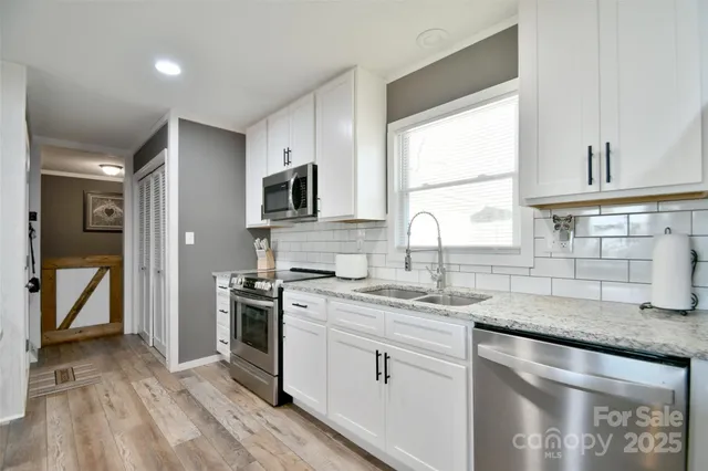 a kitchen with a sink stove and cabinets