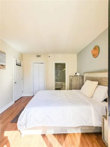 a bedroom with a bed and cabinets