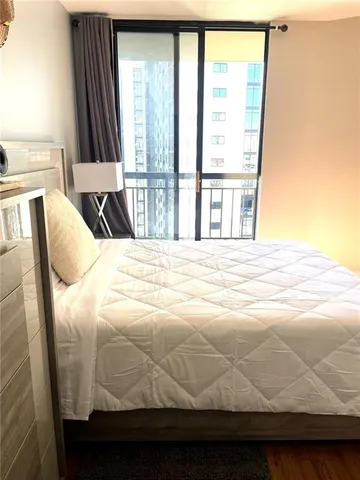 a bedroom with a bed and a large window