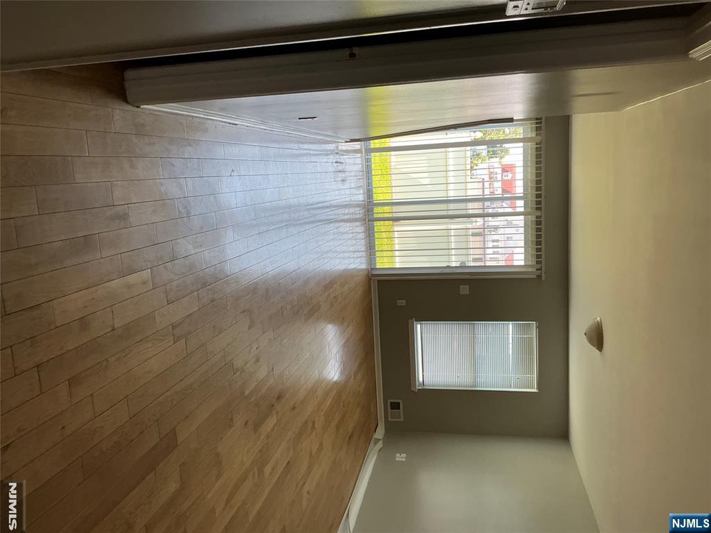 102 Berry Street, Unit 5 Hackensack, NJ 07601 - Photo 4 of 13 wooden floor in an empty room with a window