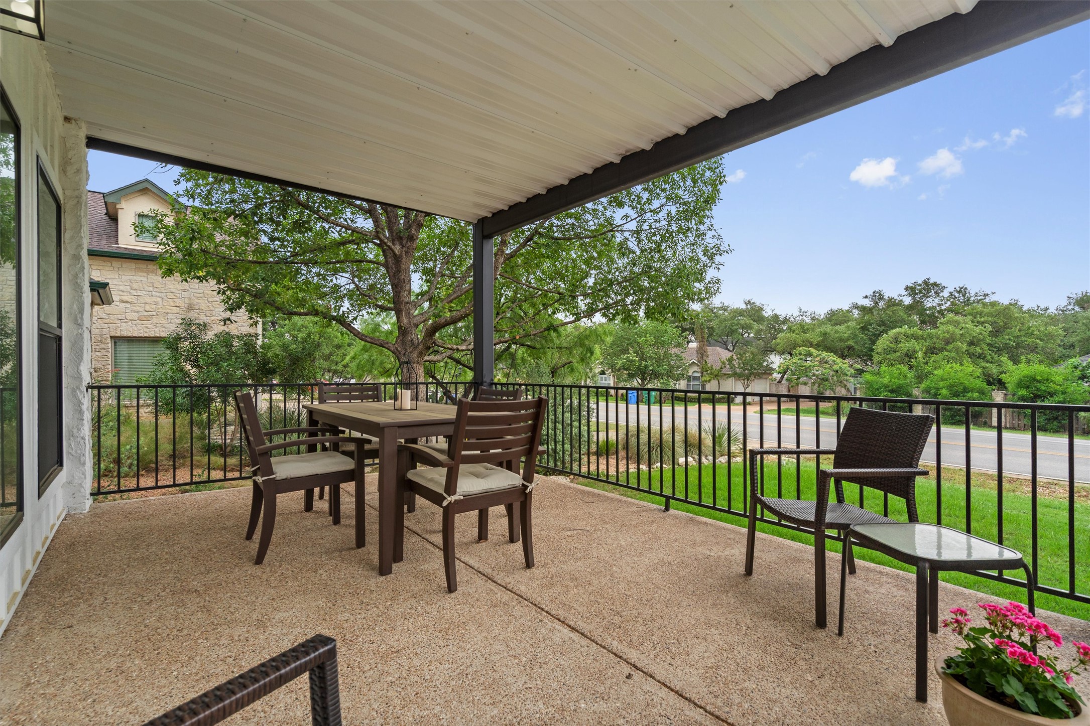 307 Hurst Creek Road Austin, TX 78734 - Photo 4 of 40 Expansive covered patio featuring a textured concrete surface, black metal railing, and a white paneled ceiling