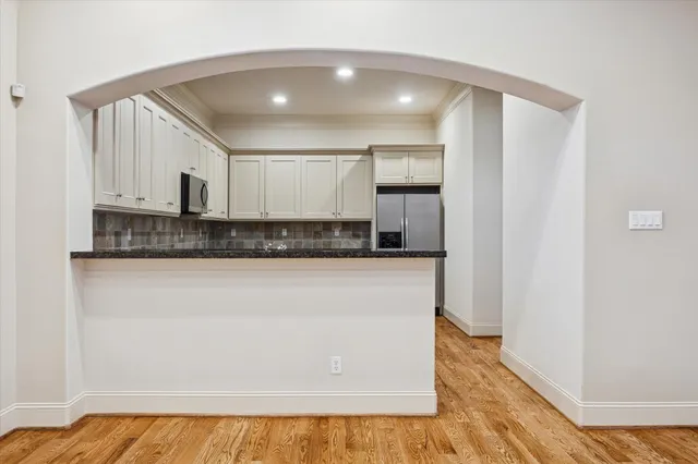 a view of empty room with wooden floor and fireplace