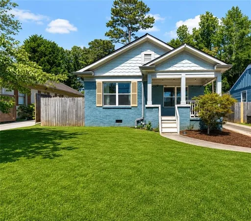 a front view of a house with a yard and porch