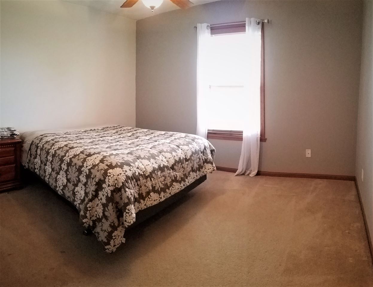 1760 South Weldon Road Rockford, IL 61102 - Photo 12 of 22 a bed sitting in a bedroom next to a window