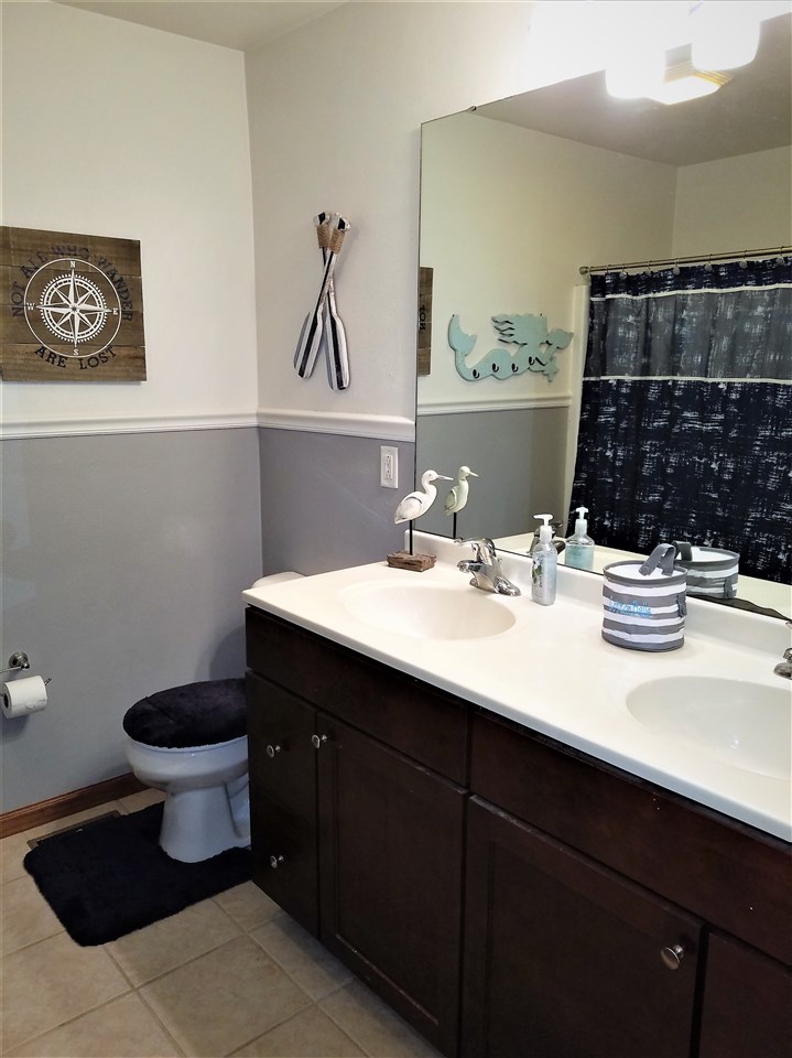 1760 South Weldon Road Rockford, IL 61102 - Photo 13 of 22 a bathroom with a sink and a toilet