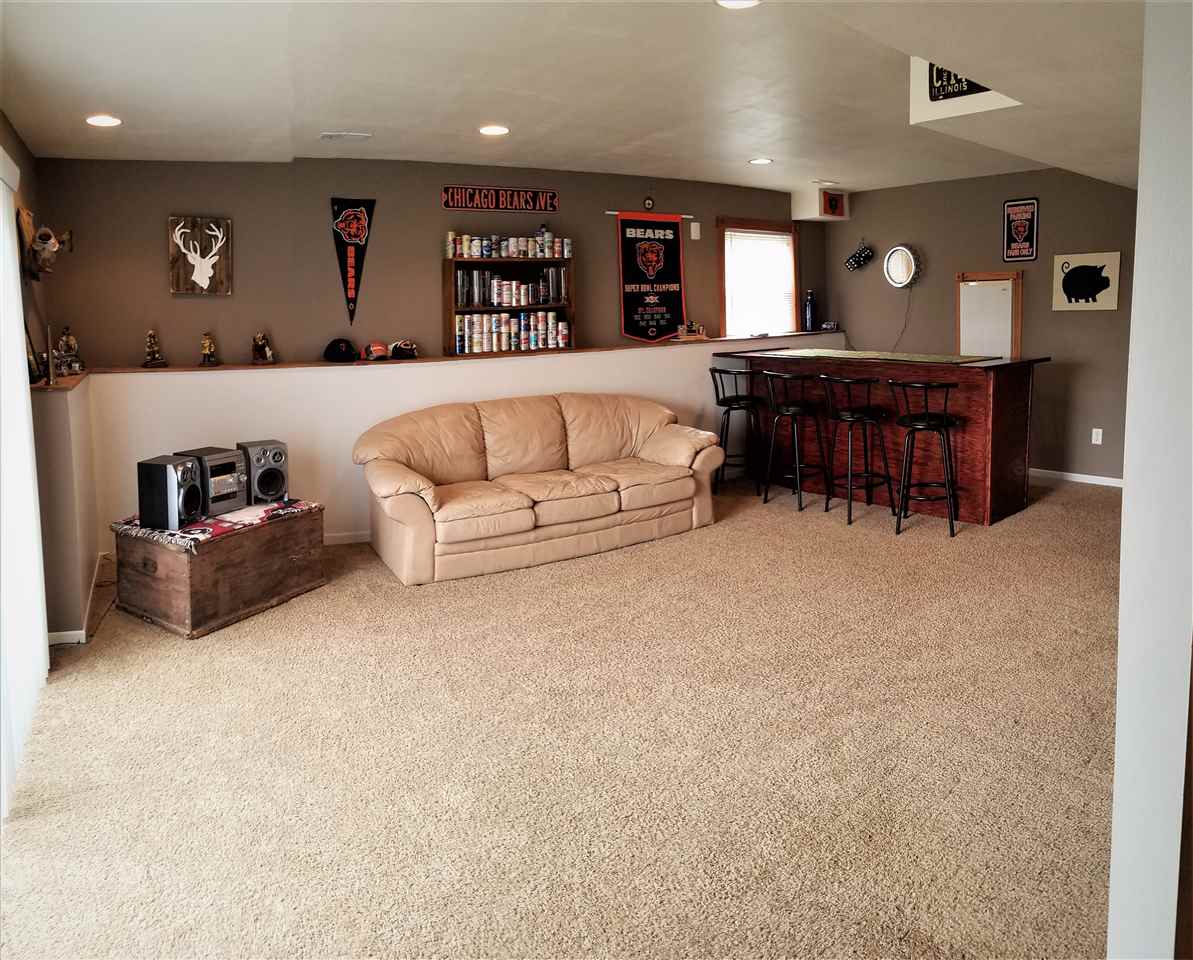1760 South Weldon Road Rockford, IL 61102 - Photo 15 of 22 a living room with furniture and a large mirror with a bookshelf