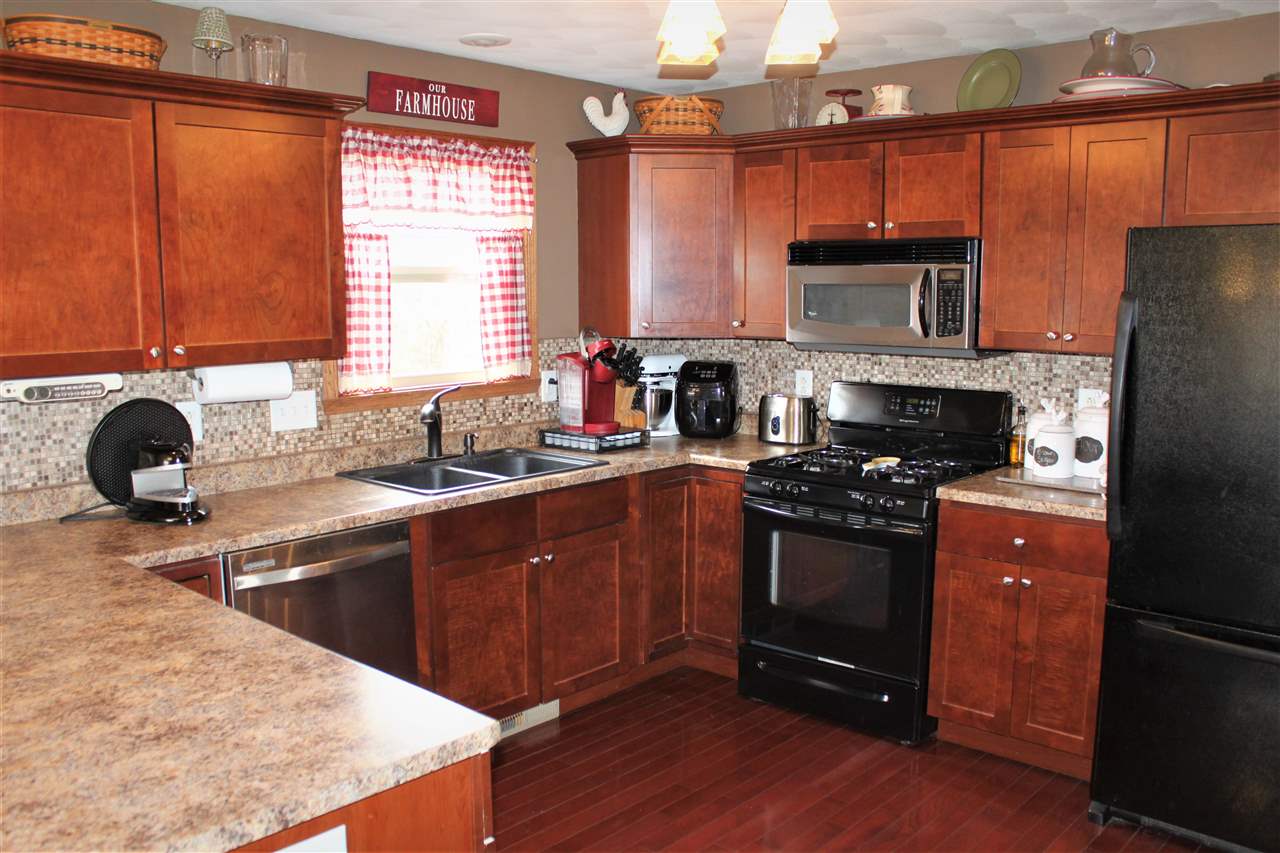 1760 South Weldon Road Rockford, IL 61102 - Photo 5 of 22 a kitchen with stainless steel appliances granite countertop a sink stove and refrigerator