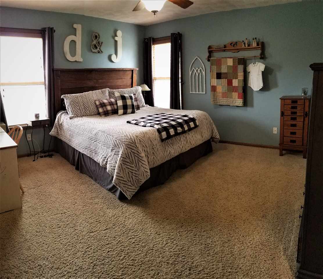 1760 South Weldon Road Rockford, IL 61102 - Photo 7 of 22 a bedroom with a bed lamp and dresser