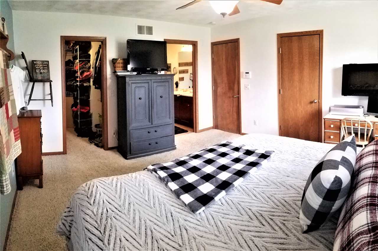 1760 South Weldon Road Rockford, IL 61102 - Photo 8 of 22 a bedroom with a bed and flat screen tv