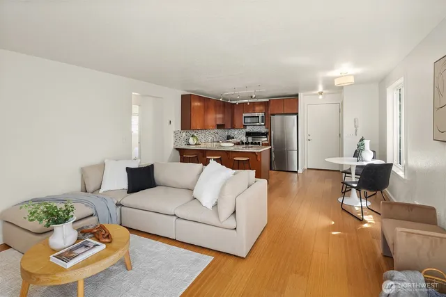 a living room with furniture and a wooden floor