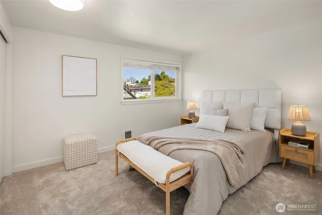 a bedroom with a bed and a painting on the wall