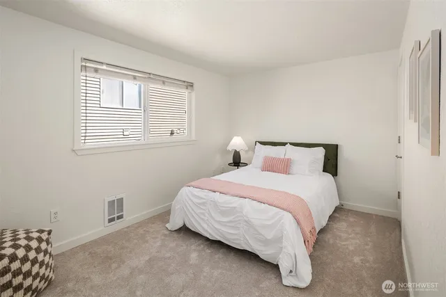 a bedroom with a bed and window