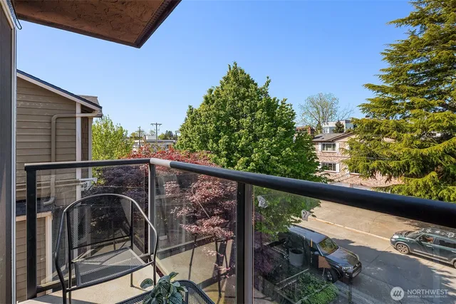 a view of a balcony with chairs and a table
