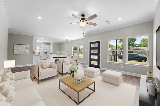 a living room with furniture and a large window