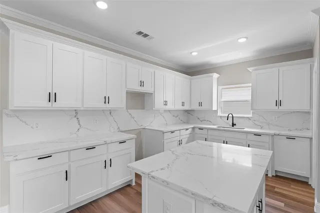 a kitchen with a sink stove and cabinets