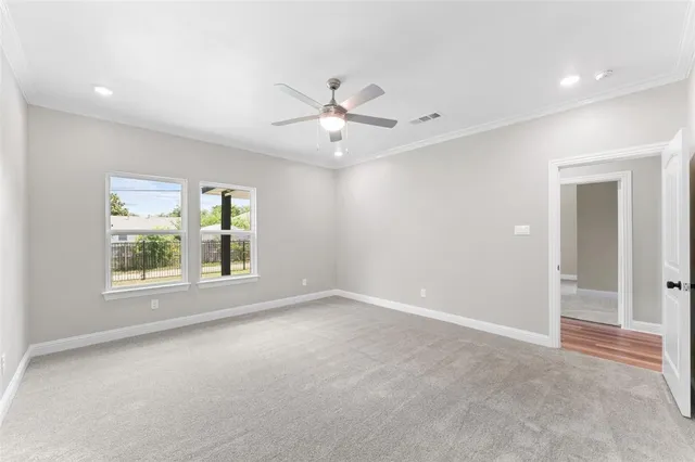 an empty room with closet and windows