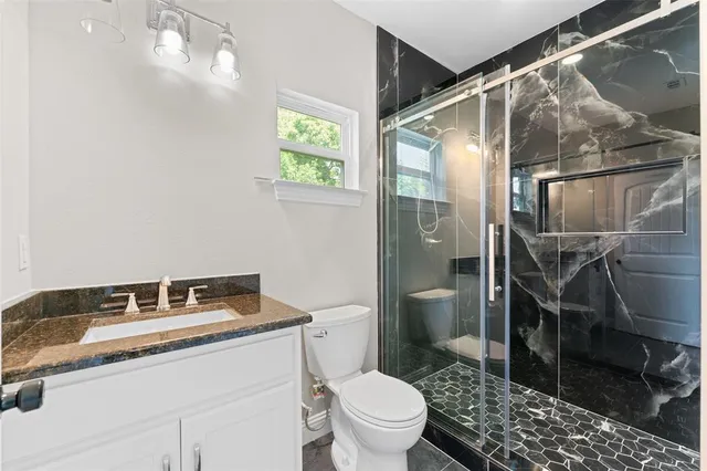 an empty room with ceiling fan and window